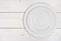 Pile of two white plates on bleached wooden plank background