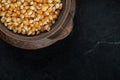 Pile of uncooked corn grains in ancient mug