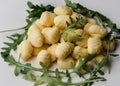 Pile of Uncooked Gnocchi with arugula