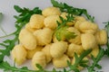 Pile of Uncooked Gnocchi with arugula