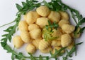 Pile of Uncooked Gnocchi with arugula