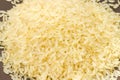 Pile of uncooked parboiled rice on brown dish close-up Royalty Free Stock Photo