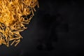 A pile of uncooked pasta on a black surface. AI generative image . A lot of copy space.