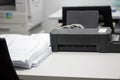 Pile of unfinished documents placed on desk with printer and cop Royalty Free Stock Photo