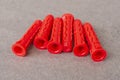 Pile of universal expansion plastic anchors isolated on a gray background. Duo power fasteners for anchoring into Royalty Free Stock Photo