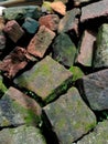 pile of unused and slightly mossy bricks Royalty Free Stock Photo