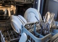 Pile of unwashed, dirty dishes in the sink. Mess in the kitchen. Dirty kitchenware, plates and mugs. Chaos at home