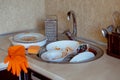 Pile of unwashed, dirty dishes in the sink. Mess in the kitchen. Dirty kitchenware, plates and mugs