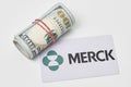 Pile of us dollars and Merck card