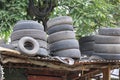 Pile of used and abandoned automotive tires on the top of the roof