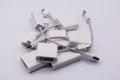 Pile of used Apple Mini DisplayPort and USB Ethernet Adapters on white background