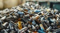 Pile of used batteries of various sizes and types scattered on a surface, representing electronic waste and recycling Royalty Free Stock Photo