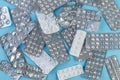 A pile Used blister packs of pills on blue background Royalty Free Stock Photo