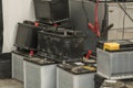 Pile of used car batteries on the floor in a garage workshop. Royalty Free Stock Photo