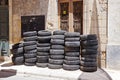 Pile of used car rubber tires near auto garage on street Royalty Free Stock Photo