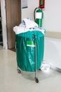 A pile of used clothes in hospital movable trolley with green ba Royalty Free Stock Photo