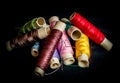 Pile of used colorful spools of thread tailoring Royalty Free Stock Photo
