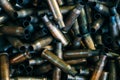 Pile of used rifle cartridges 7.62 mm caliber, many empty bullet shells, assault rifle bullet shell, military background, top view