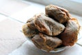 Pile of used teabags on a teabag shaped plate on a kitchen windowsill Royalty Free Stock Photo