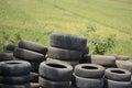 pile of used tires near the rice fields. Royalty Free Stock Photo
