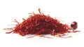 Pile of vibrant red saffron threads and a single saffron corm isolated on white backdrop Royalty Free Stock Photo