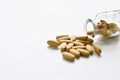 A pile of vitamin pills with clear glass bottles on a white background. Royalty Free Stock Photo