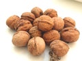 A pile of walnuts on a white background