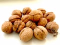 A pile of walnuts on a white background. Exclusive three-walnut