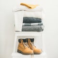 Pile of warm sweaters, blankets, cap and boots, square crop Royalty Free Stock Photo