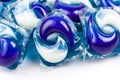 A pile of washing dishwasher or laundry blue white chemical detergent pods, packs, pouches closeup macro detail. Household items Royalty Free Stock Photo