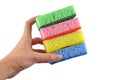 A pile of washing sponges (yellow, green pink and blue) in a hand Royalty Free Stock Photo