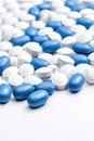 Pile of white-blue medical capsules. Blue white pills capsul.