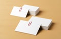 Pile of white businesscards with a clip on beige background