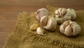 A pile of white garlic cloves and bulb peeled on vintage sack, a good food condiment vegetable for health and medicine