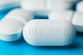 Pile of white PAXLOVID antiviral drug pills phar Royalty Free Stock Photo