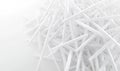 Pile of white plastic stirrers on a white background, for environmental or waste concepts Royalty Free Stock Photo