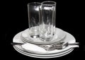 Pile of white plates, glasses, forks, spoons. Royalty Free Stock Photo