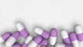 Pile of white and purple medicine capsules