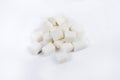 Pile of the white refined sugar cubes on light surface Royalty Free Stock Photo