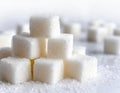 A pile of white sugar cubes on a white background Royalty Free Stock Photo