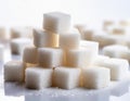A pile of white sugar cubes on a white background