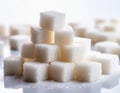 A pile of white sugar cubes on a white background Royalty Free Stock Photo