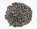 Pile of whole black urad beans close up on gray