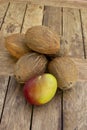 A Pile of whole coconuts on the wood table.