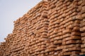 A pile of wood with a layer of snow on top, showcasing the wintry weather conditions. A tall and sturdy pile of wooden Royalty Free Stock Photo