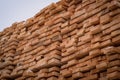 A pile of wood with a layer of snow on top, showcasing the wintry weather conditions. A tall and sturdy pile of wooden Royalty Free Stock Photo