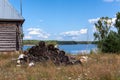 Pile of woodblocks is on backyard of timber house on lake shore, countryside landscape Royalty Free Stock Photo