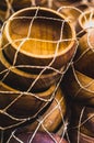 Pile of wooden ashtrays inside a net