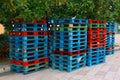 Pile of wooden euro pallets. Bunch of colourful wooden pallets. Stacks of pallets.