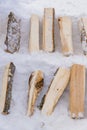 A pile of wooden firewood on the snow prepared for getting warm in winter